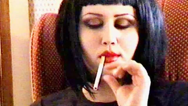 Goth girls smoke and talk at home