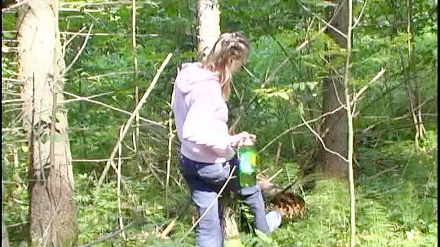 Braided hair girl pisses in the woods