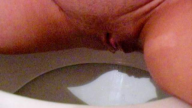 Pissing teen is naked on the toilet