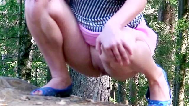 Pissing girl in a short pink skirt