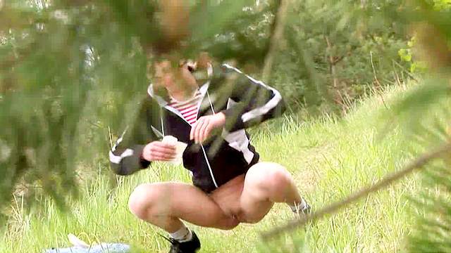 Sporty teen goes piss in the woods