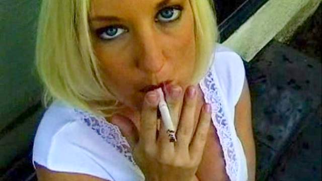 Blonde smokes outdoors in stockings