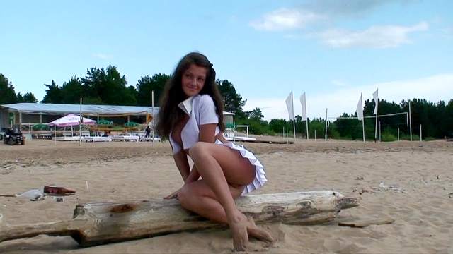 Beautiful flashing girl at the beach
