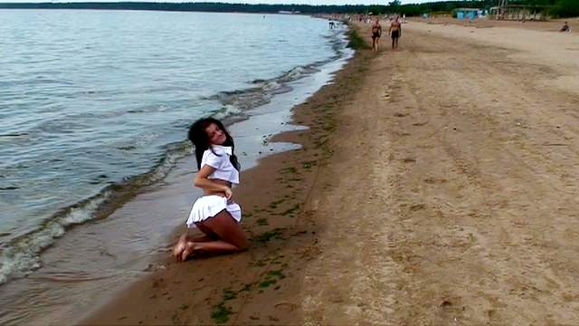 Beautiful flashing girl at the beach