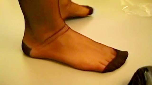Close up on sexy feet in black nylons