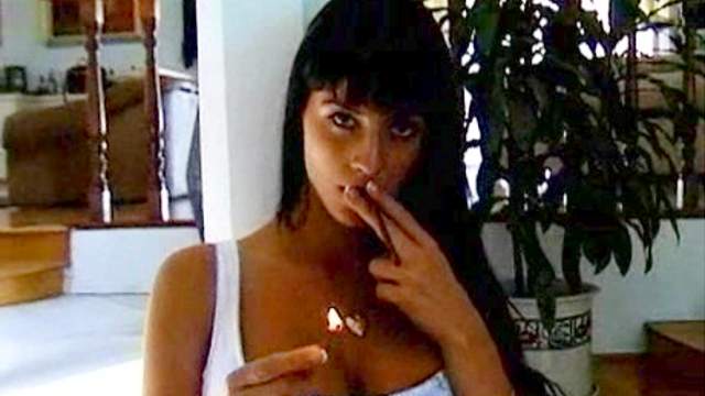 Girl in a white corset smokes cigarette