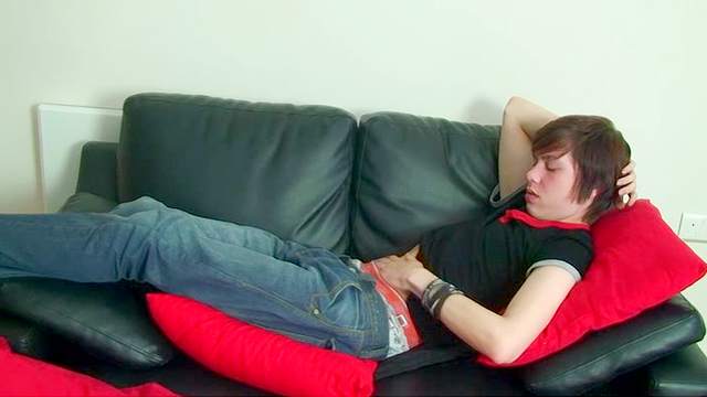 Jack Styles lying on the leather sofa and masturbating