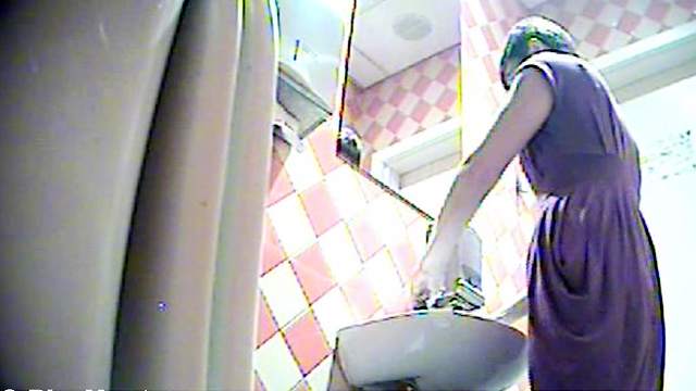 Sexy cutie with green hairs is pissing in the toilet