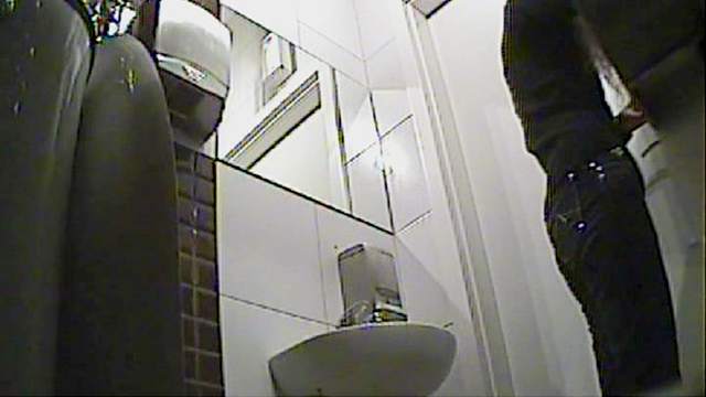 Curly blonde with skinny body is pissing in the toilet