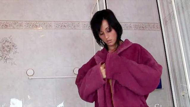 Brunette Simone Style is washing her body in the shower