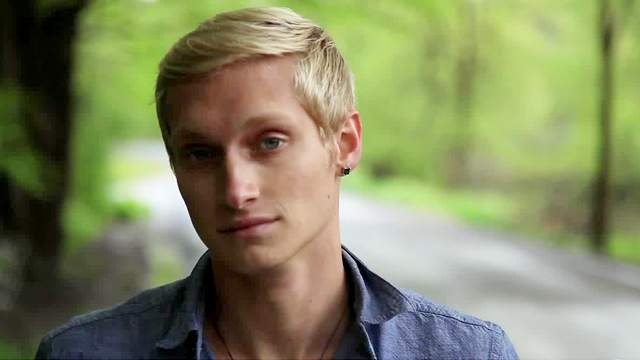 Hot blond gay Max Carter is masturbating while sitting