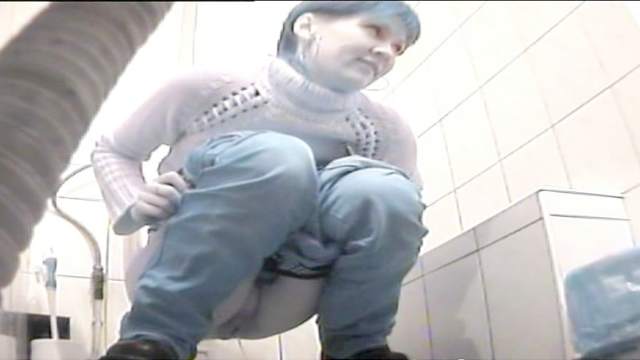 Hot babe is pissing in the public toilet