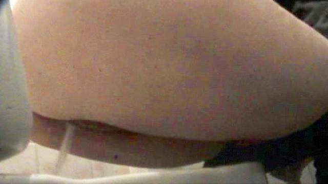 Sexy unknown babe is pissing in the toilet