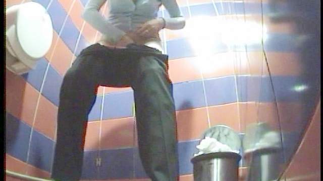 Brunette is taking off her cute black pants