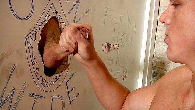 Hot bald gay sucks a dick through the hole in the wall
