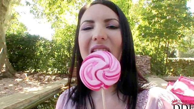 Slender babe Karina Heart is sucking a candy